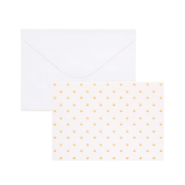 Gift card with gold polka dots and white envelope behind.