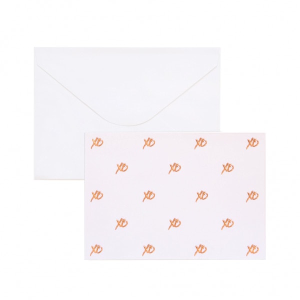 Gift card with rose gold XO, kisses and hugs. White envelope behind.