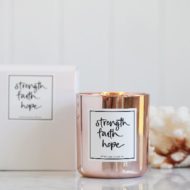 Lemon Canary's rose gold 'Strength Faith Hope' soy candle with box and white coral behind