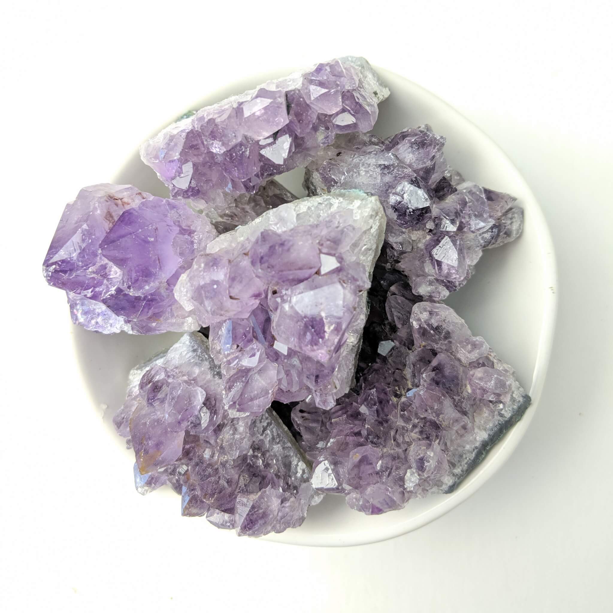 Amethyst Crystal Clusters in a White Bowl Top View