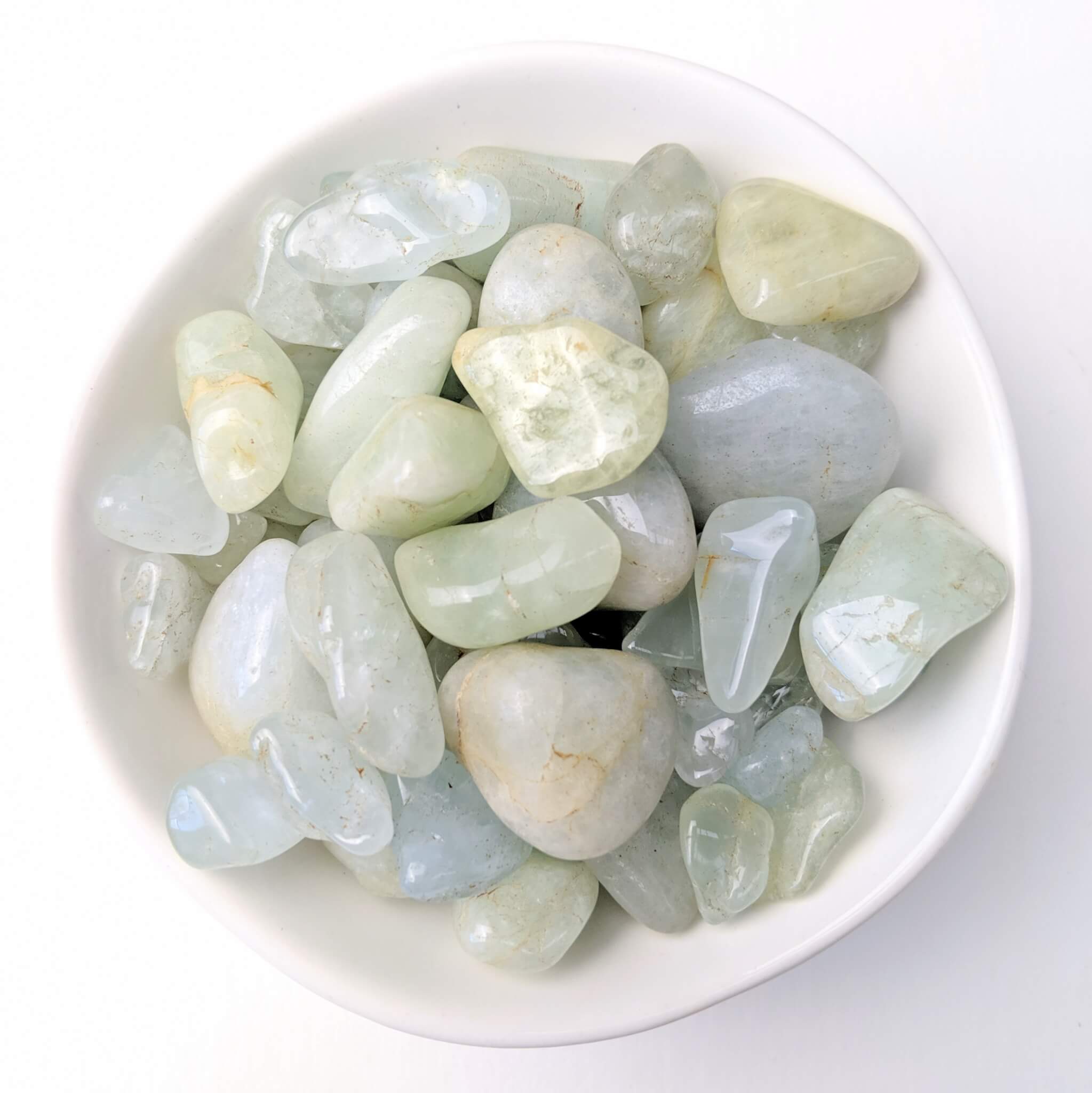 Aquamarine Crystal Tumble Stones in a White Bowl Top View