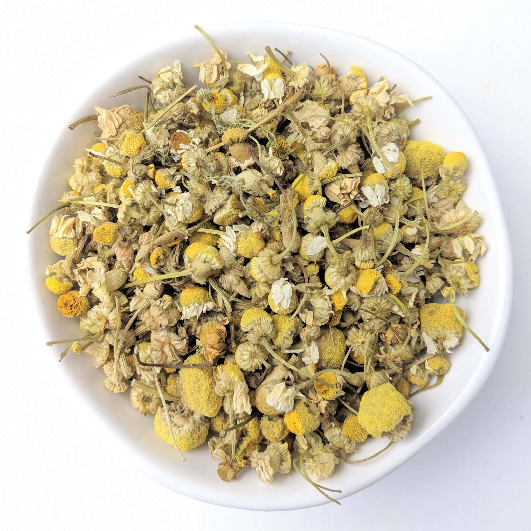 Organic Chamomile Flowers in a White Bowl Top View