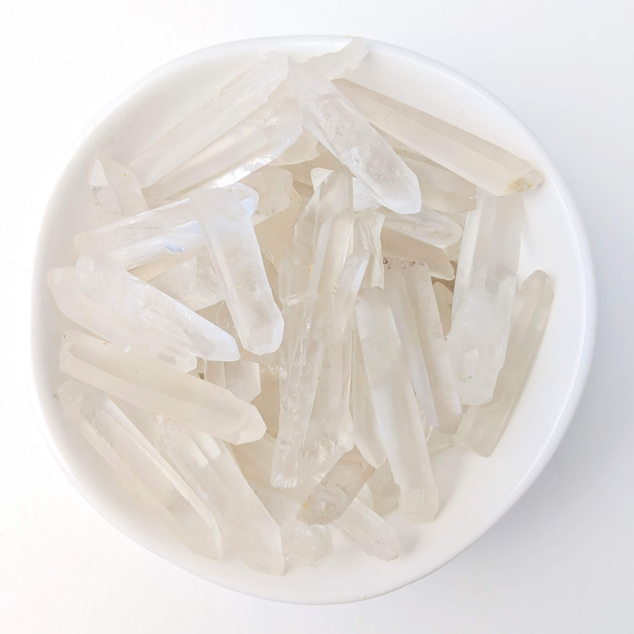 Clear Quartz Crystal Points in a White Bowl Top View