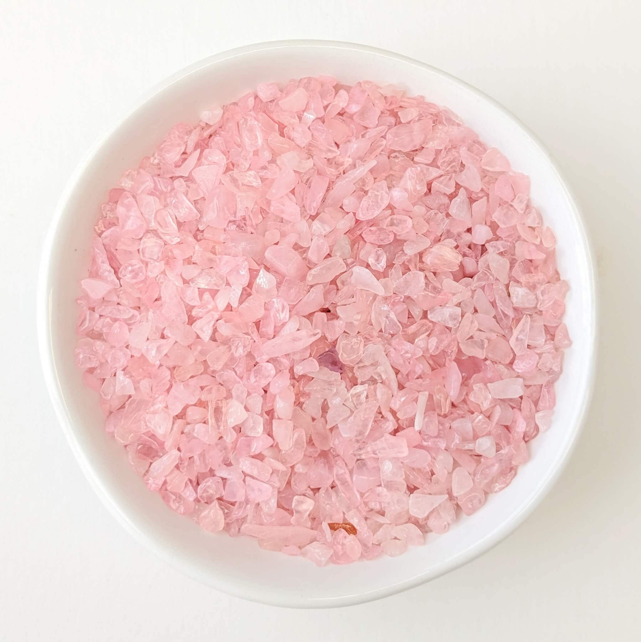 Rose Quartz Crystal Chips in a White Bowl Top View