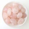 Rose Quartz Crystal Tumble Stones In A White Bowl Top View