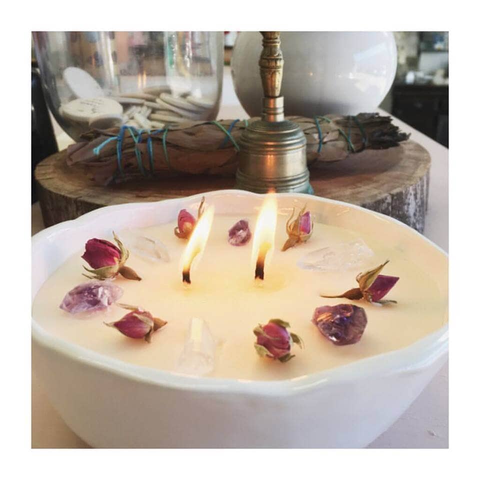 Restore soy candle bowl with lit wicks. Scented with Mystique, a 100% organic essential oil scent by Lemon Canary